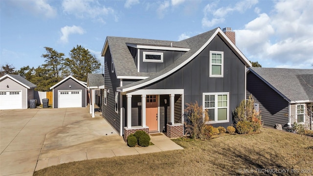 view of front of home with a garage, an outdoor structure, and a front lawn