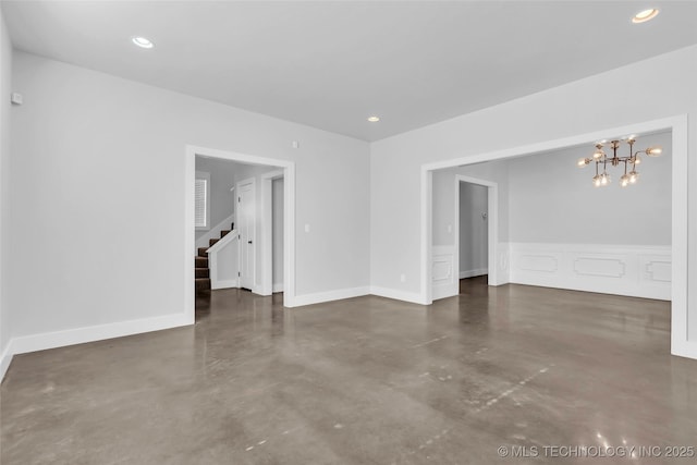 spare room featuring an inviting chandelier