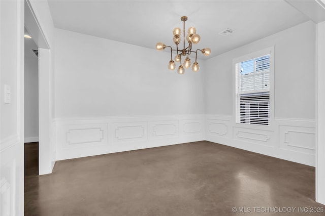 empty room featuring an inviting chandelier