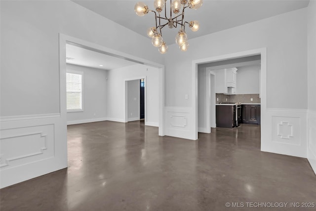 unfurnished dining area with an inviting chandelier