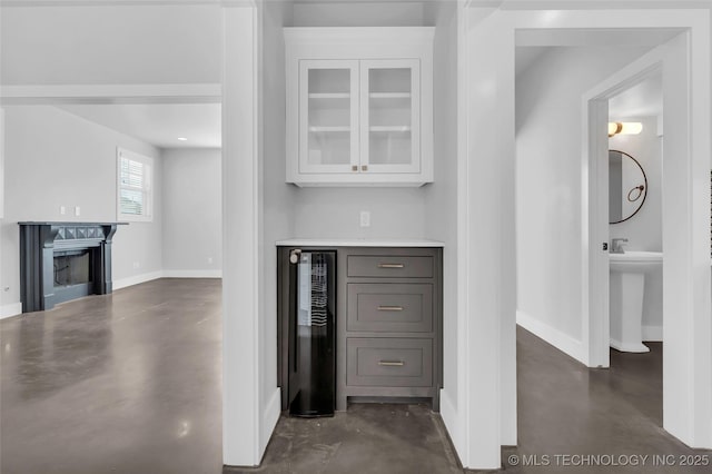 kitchen featuring white cabinetry and wine cooler