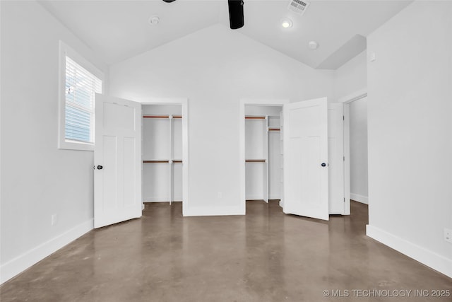 unfurnished bedroom featuring ceiling fan, high vaulted ceiling, and two closets