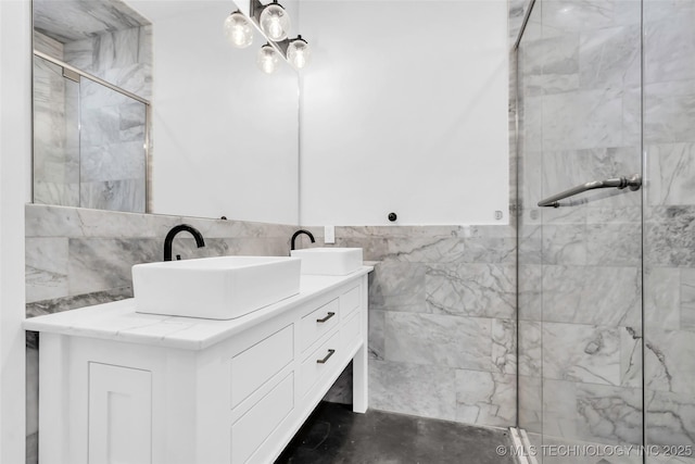 bathroom featuring vanity, an enclosed shower, and tile walls