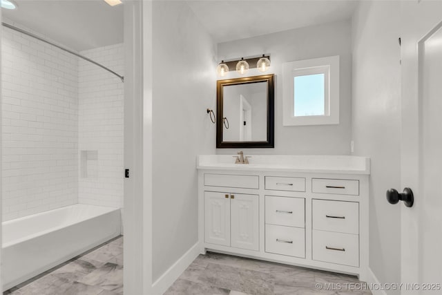 bathroom featuring vanity and tiled shower / bath