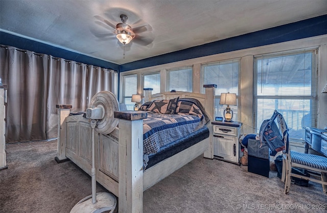 carpeted bedroom with multiple windows, a textured ceiling, and ceiling fan