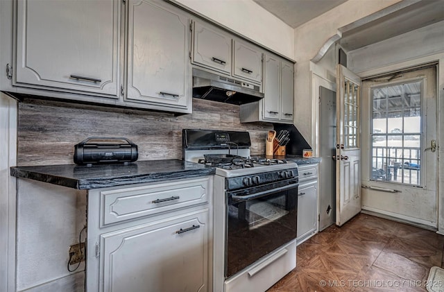 kitchen with dark parquet flooring and white gas range