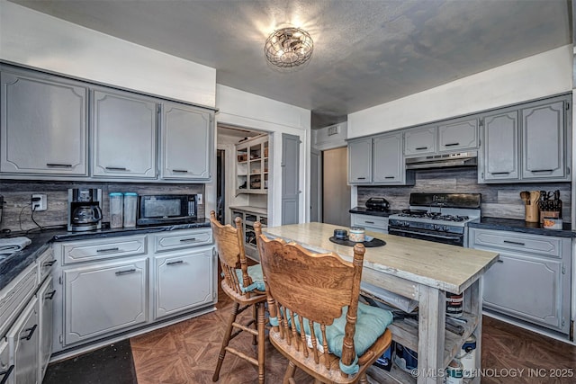 kitchen with dark parquet floors, tasteful backsplash, gray cabinetry, and black appliances