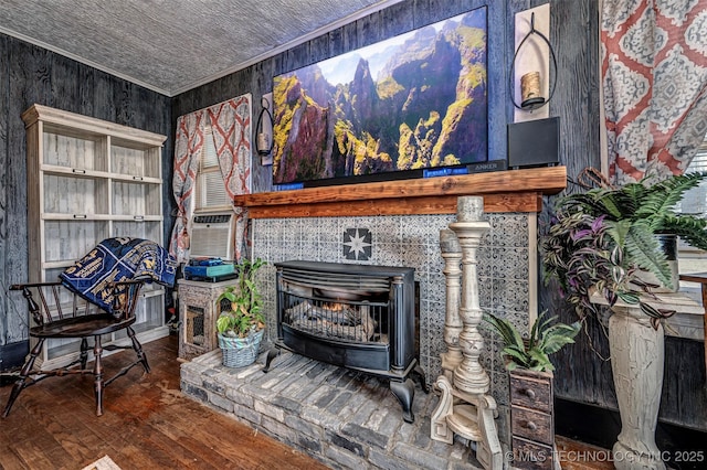 interior space featuring a wood stove, hardwood / wood-style floors, cooling unit, and ornamental molding