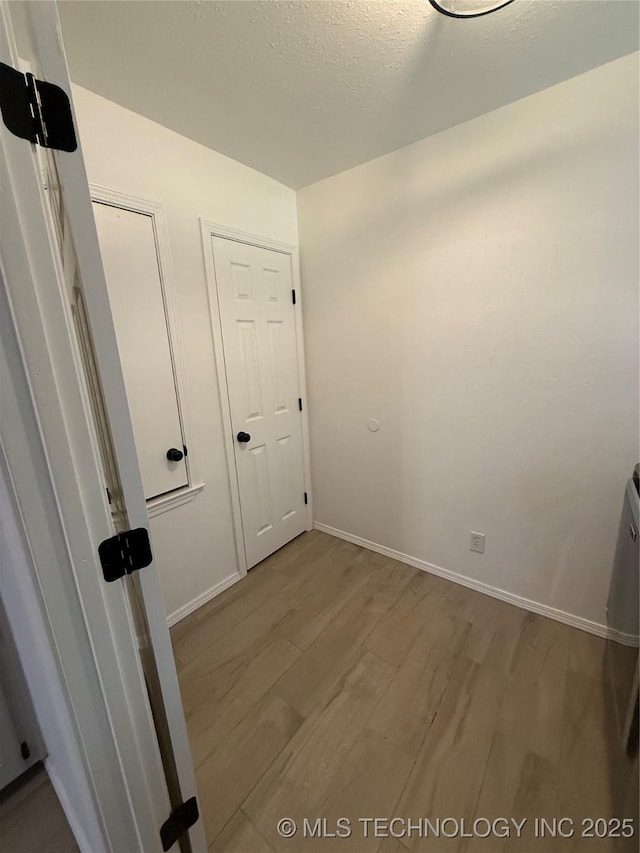 interior space with light hardwood / wood-style flooring and a textured ceiling