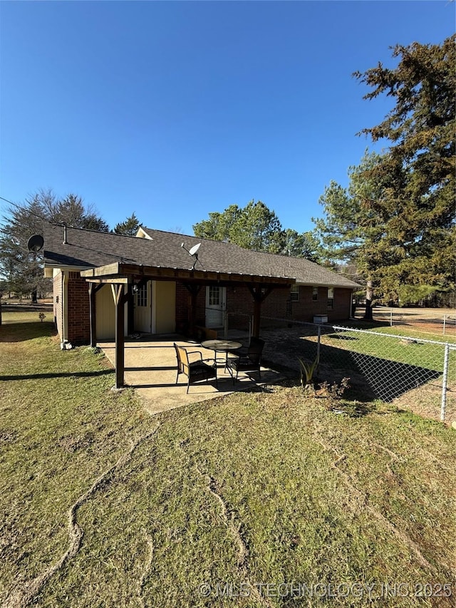 rear view of property with a yard and a patio