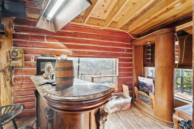 interior space featuring wood-type flooring and log walls