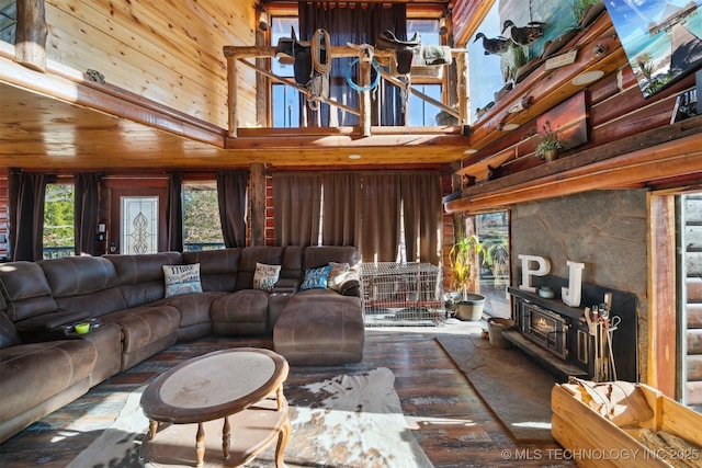 living room with wood walls, wood-type flooring, and a high ceiling