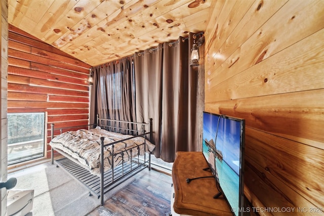 bedroom with wooden walls, wood ceiling, vaulted ceiling, and wood-type flooring