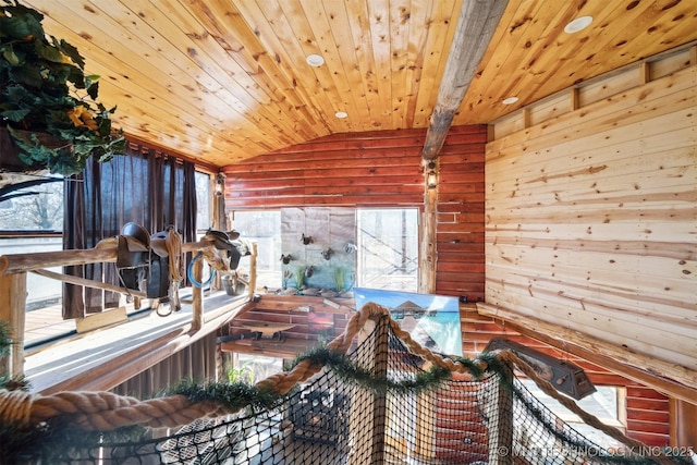 miscellaneous room with vaulted ceiling with beams, wood walls, and wooden ceiling