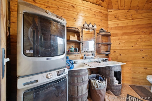 washroom featuring wooden walls, wooden ceiling, and stacked washer / drying machine