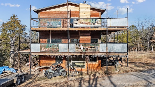 back of house with a balcony and a deck