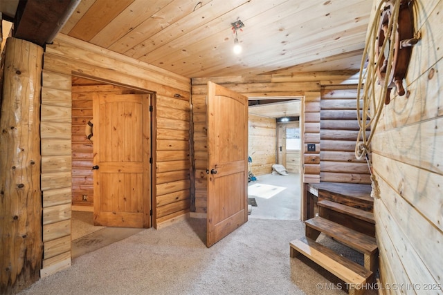 interior space featuring carpet flooring, lofted ceiling, wooden ceiling, and rustic walls