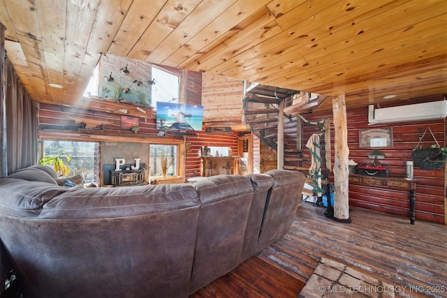 living room featuring log walls, dark hardwood / wood-style floors, a wall mounted air conditioner, and wooden ceiling