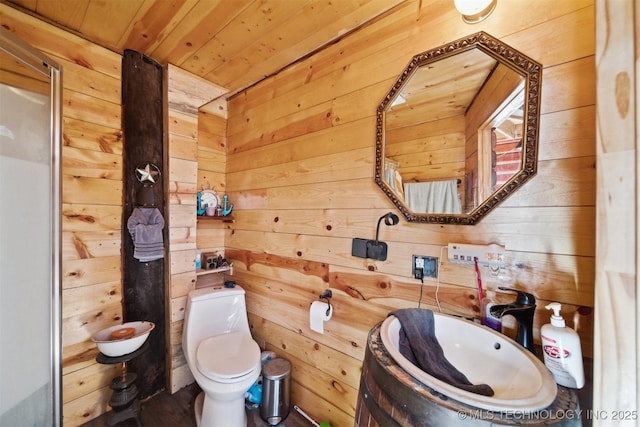 bathroom with vanity, toilet, wooden ceiling, and wooden walls