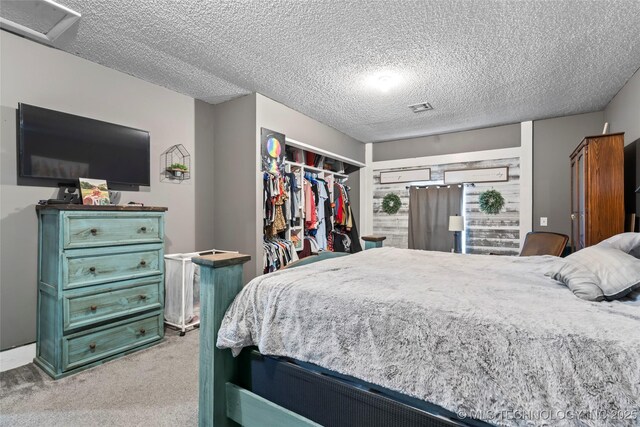 bedroom with carpet, a textured ceiling, and a closet