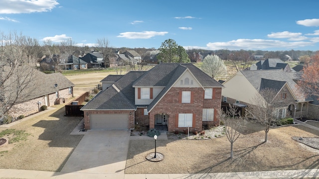 view of front of house featuring concrete driveway, an attached garage, a residential view, and brick siding