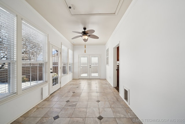 unfurnished sunroom featuring french doors and ceiling fan