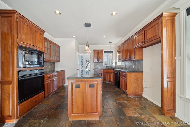 kitchen featuring tasteful backsplash, crown molding, black appliances, decorative light fixtures, and a kitchen island