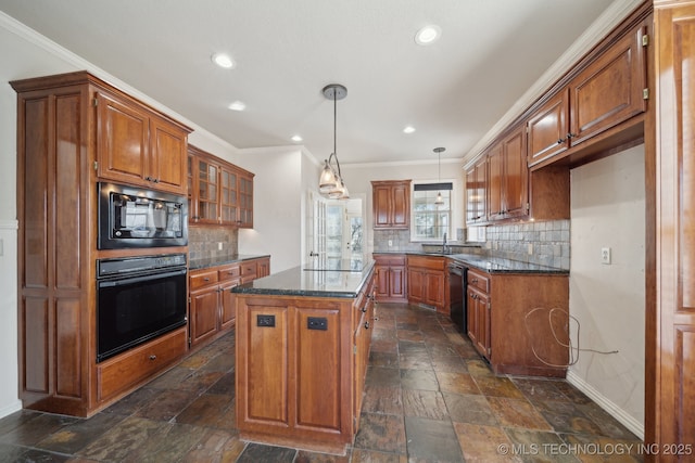 kitchen featuring baseboards, brown cabinetry, black appliances, and stone tile flooring