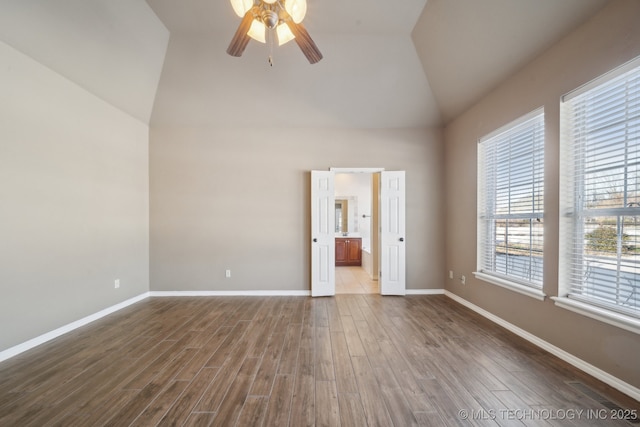 unfurnished room featuring wood-type flooring, ceiling fan, and lofted ceiling