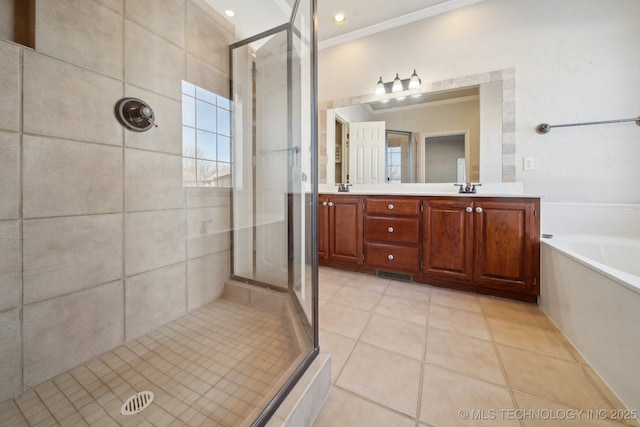 bathroom with tile patterned floors, vanity, ornamental molding, and shower with separate bathtub