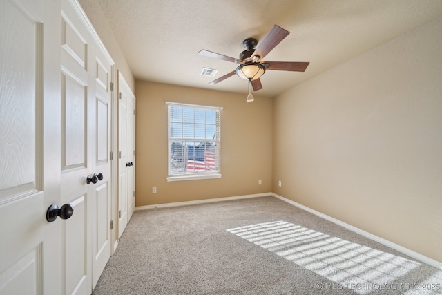 spare room with light carpet and ceiling fan