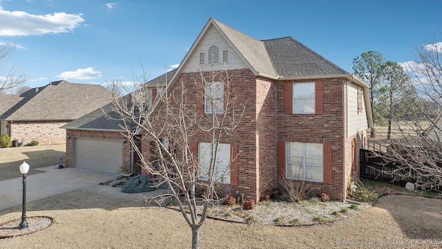 view of front of home featuring concrete driveway, brick siding, roof with shingles, and a garage