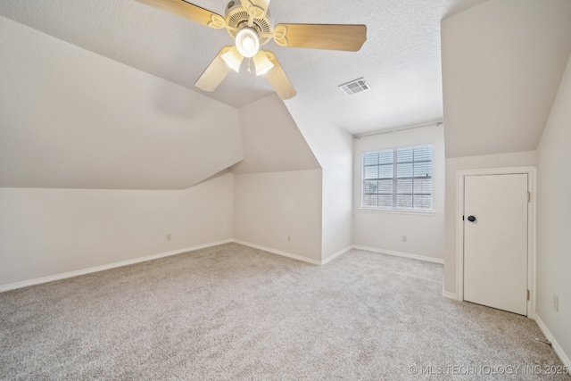 bonus room featuring visible vents, a ceiling fan, carpet, and vaulted ceiling
