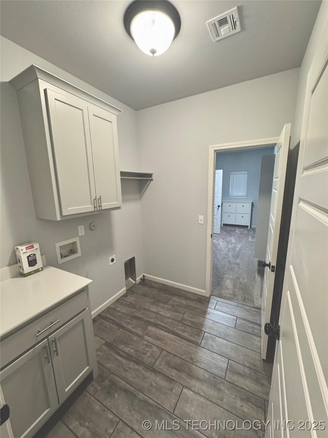 laundry room featuring washer hookup, electric dryer hookup, and cabinets