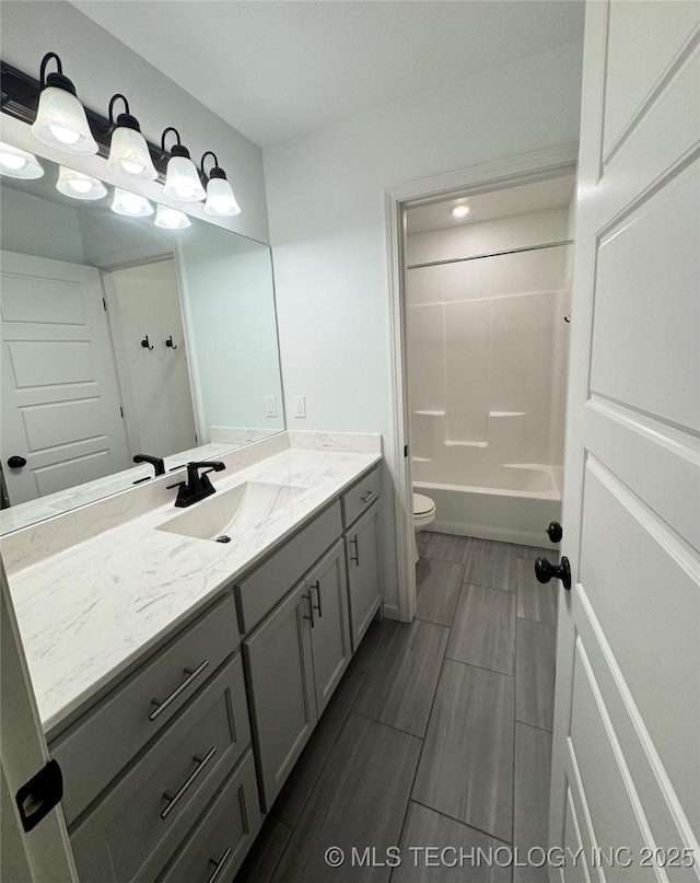 full bathroom featuring vanity, toilet, and tub / shower combination