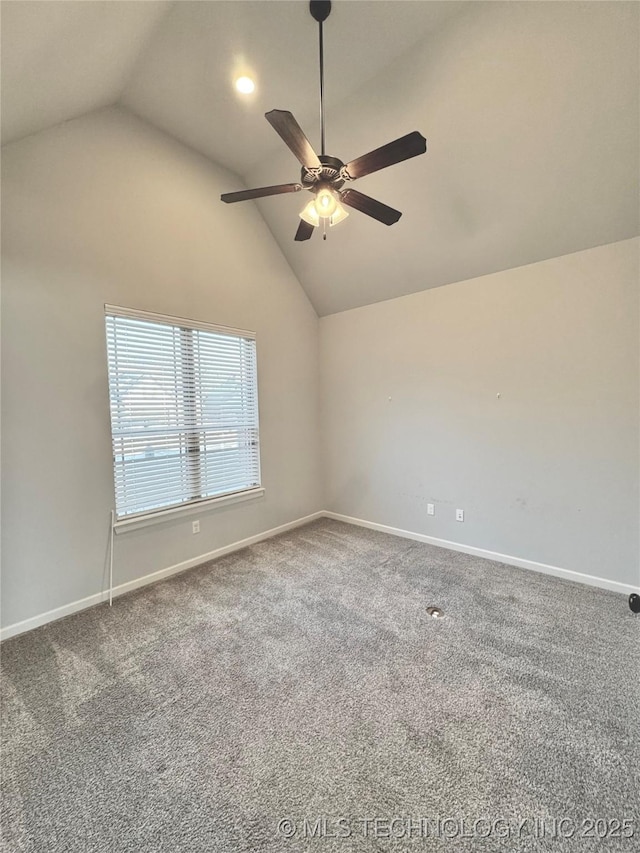 carpeted empty room with ceiling fan and vaulted ceiling