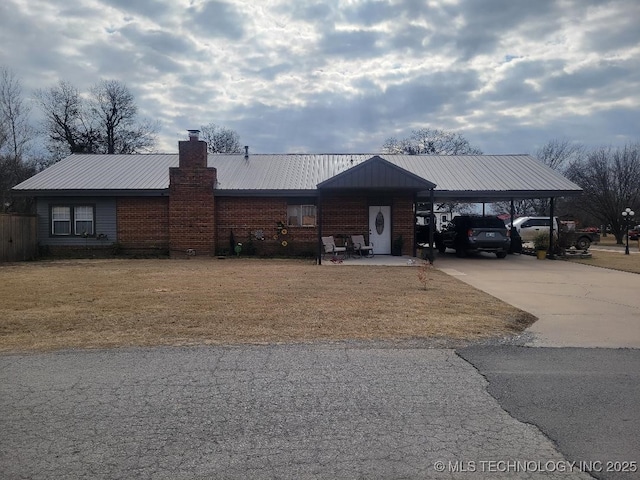 ranch-style house with a front yard and a carport