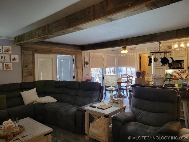 living room with beamed ceiling and ceiling fan