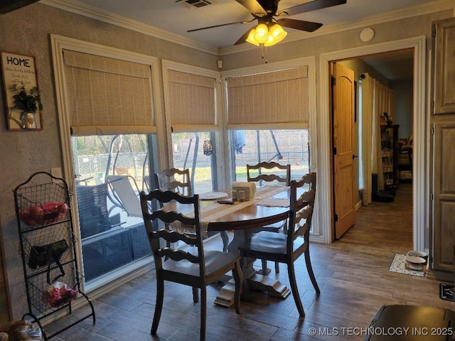 dining room with ceiling fan, hardwood / wood-style floors, and ornamental molding