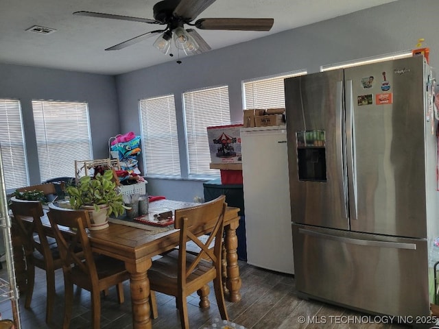 dining space featuring ceiling fan, dark hardwood / wood-style flooring, and a wealth of natural light