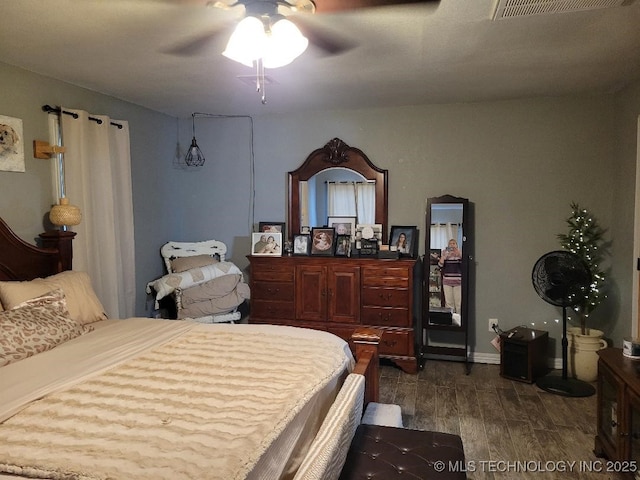 bedroom featuring ceiling fan and dark hardwood / wood-style flooring