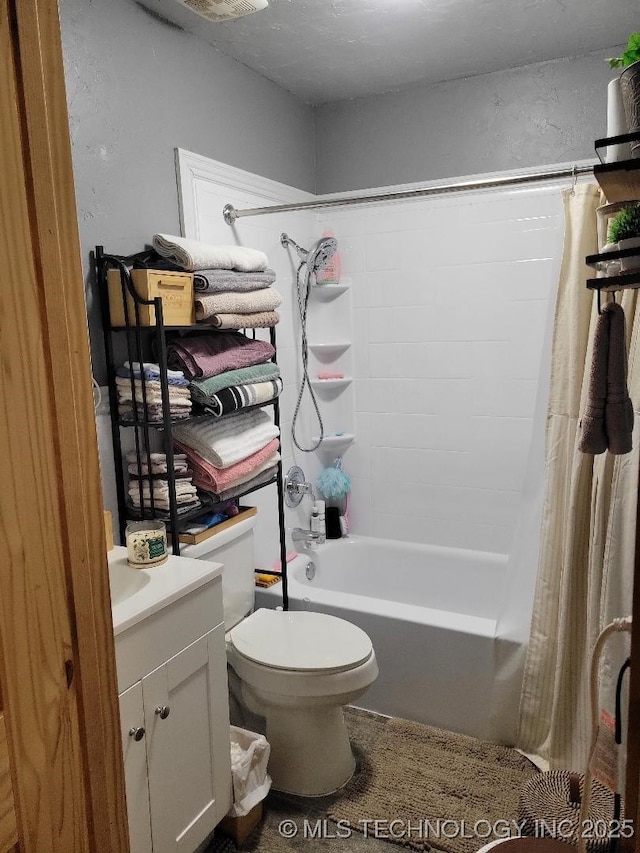 full bathroom featuring shower / tub combo with curtain, vanity, and toilet