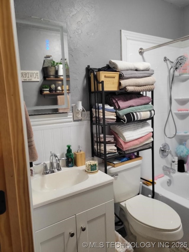 full bathroom with shower / tub combination, vanity, and toilet