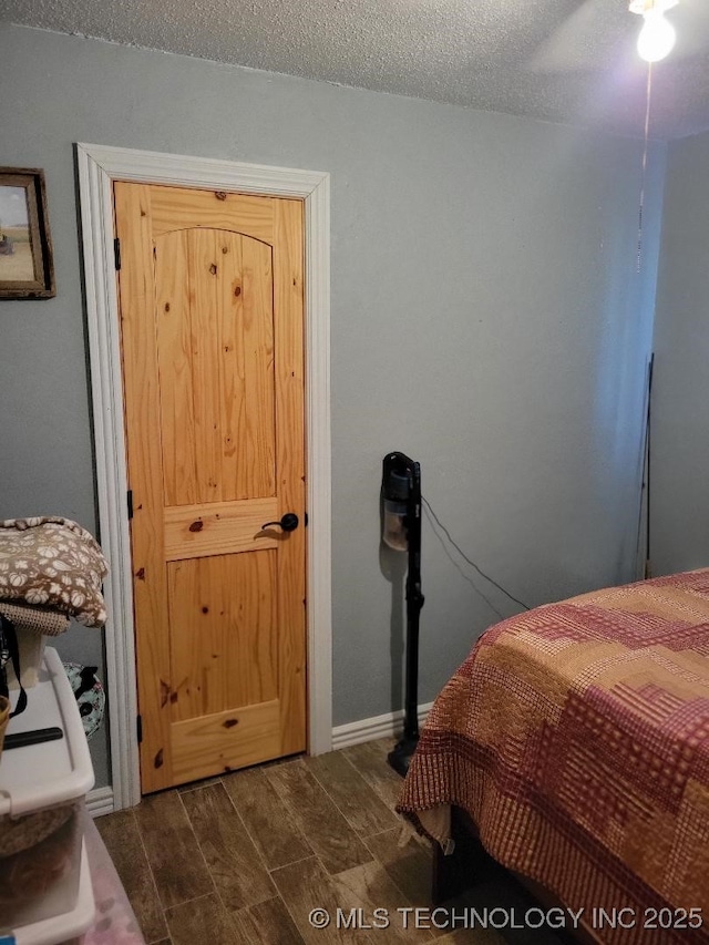 bedroom with a textured ceiling and ceiling fan