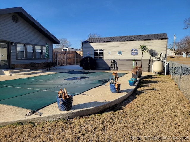 exterior space with a covered pool and a patio area