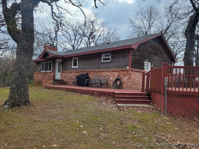 view of property exterior featuring a yard and a deck