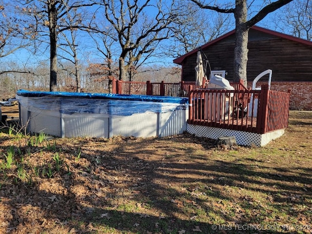 view of swimming pool with a deck