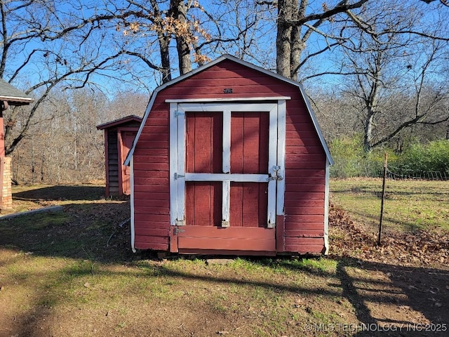 view of outbuilding featuring a yard