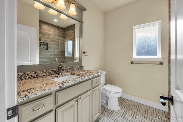 bathroom featuring vanity, toilet, and walk in shower