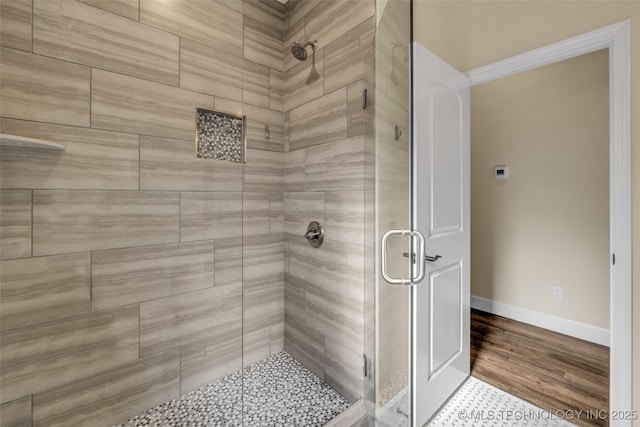 bathroom with a shower with door